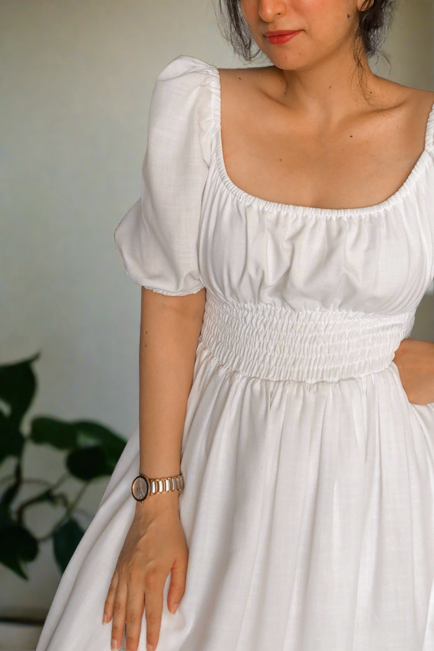 white cotton midi dress with smocking around the waist for ease of wearing and elastic on the shoulder and neckline.it is fully lined. light and floaty