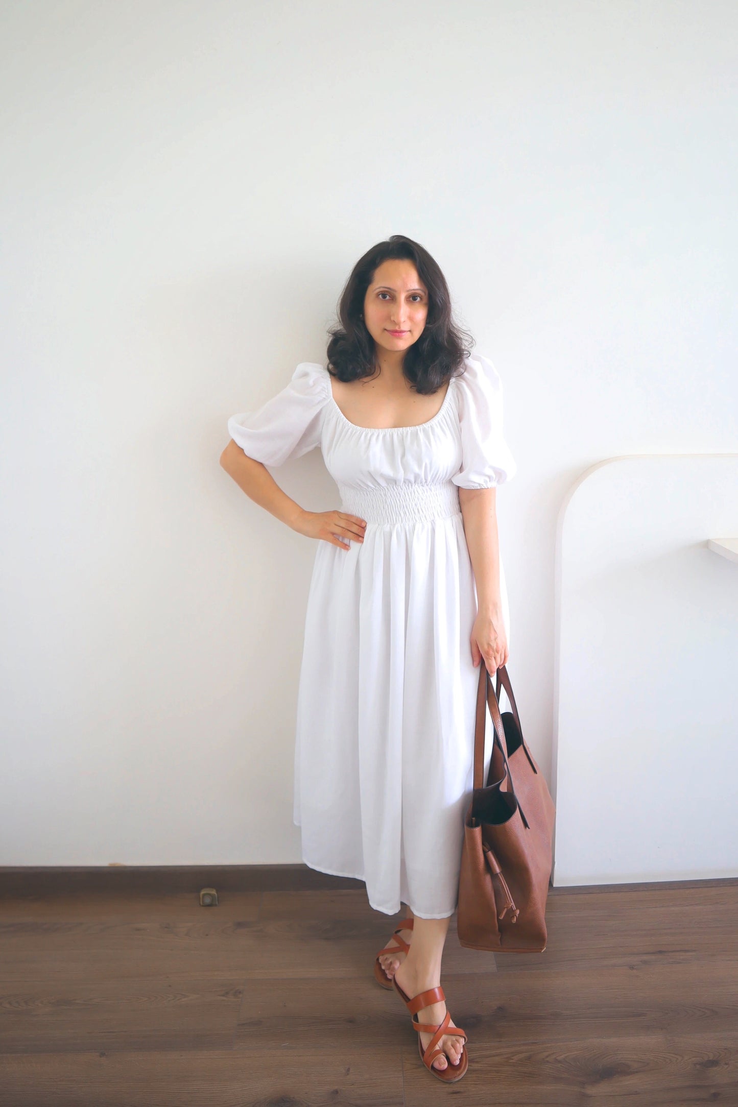 white cotton midi dress with smocking around the waist for ease of wearing and elastic on the shoulder and neckline.it is fully lined. light and floaty