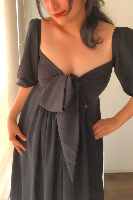 Aurora black dress is ankle length with smocking on the back and a wrap bodice that can be tied into a knot. It can be worn in reverse as well with smocking in the front. Its made with love from a beautiful imported crepe.