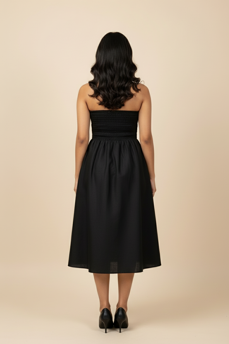 Model wearing Blue Hour Black Linen Strapless Midi Dress, back view - strapless design with flowy A-line skirt