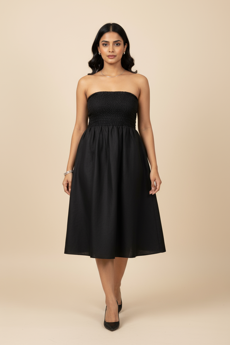 Woman wearing a black strapless dress against a beige background