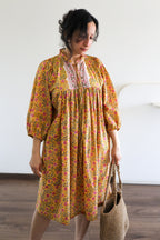 Woman wearing Evening Blush Midi Dress in Mustard Floral Handblock Sanganeri Cotton.