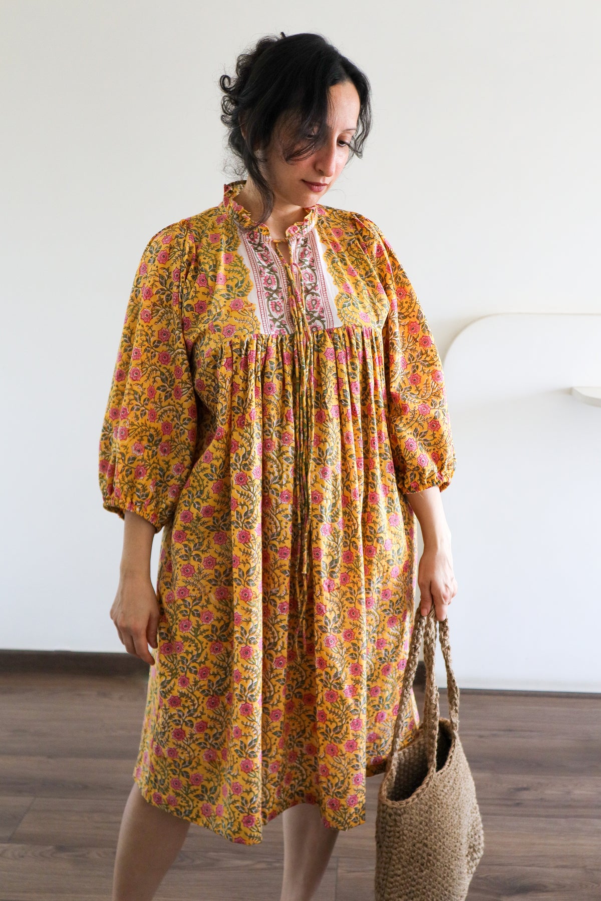 Woman wearing Evening Blush Midi Dress in Mustard Floral Handblock Sanganeri Cotton.