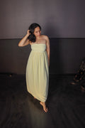 Woman wearing Golden Hour Buttercream Yellow Strapless Vacation Maxi Dress. Cocktails and garden party outfit.