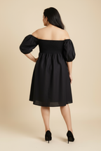 Woman in Palm dress in midnight black linen with shirred bodice and puff sleeves - back view, Close-up of shirred bodice detail and adaptive fit design