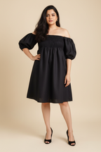 Woman in Palm dress in midnight black linen with shirred bodice and puff sleeves - front view, Close-up of shirred bodice detail and adaptive fit design