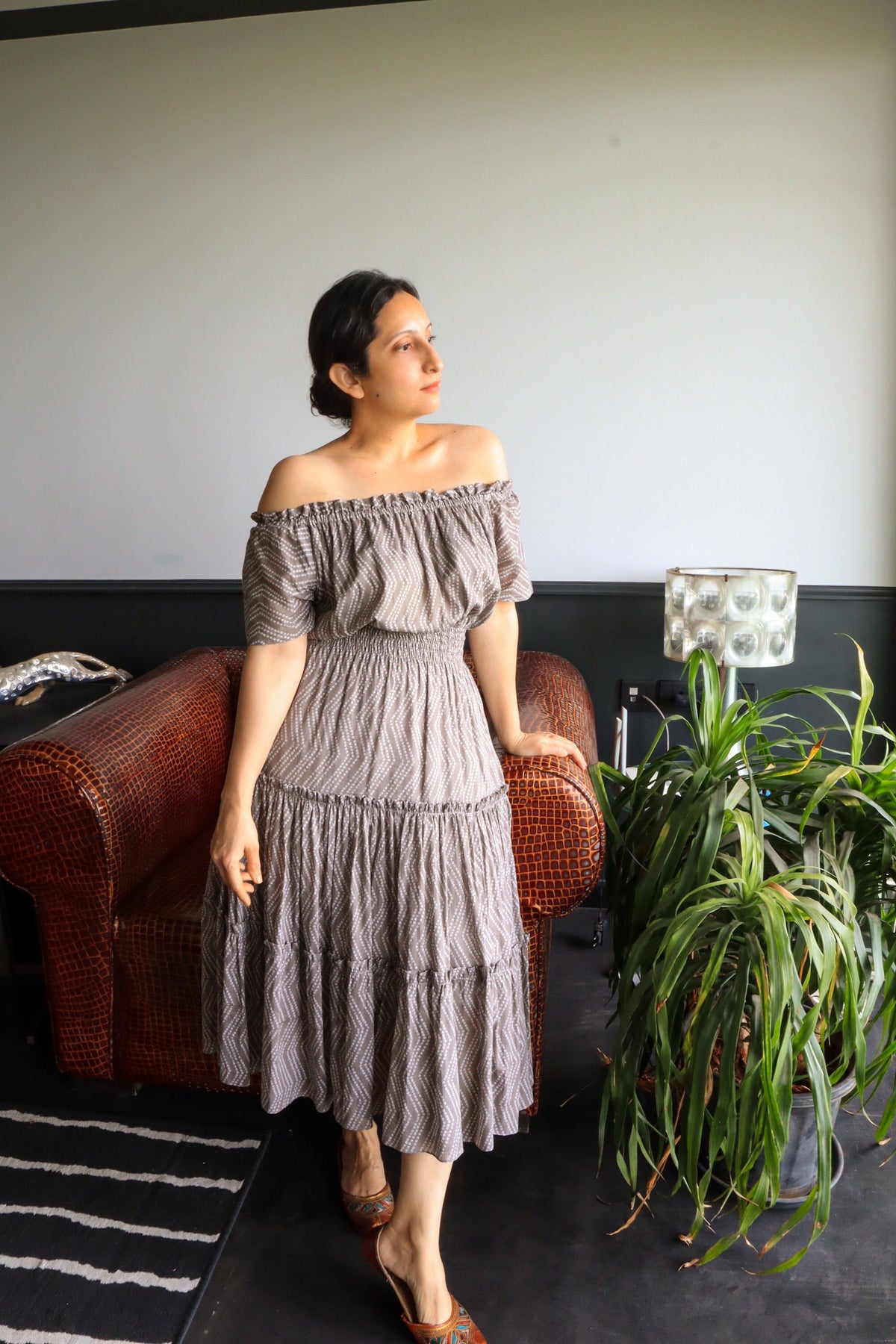 Woman in Seashell Grey Midi Dress in Mulmul Cotton Tiered silhouette, shirred waist and elasticated neckline.