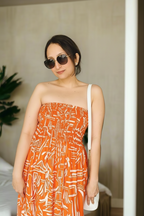 Sundown Strapless Midi Dress
is a playful, versatile dress in geometric orange that seamlessly transitions from dress to skirt, giving you two looks in one effortless piece.