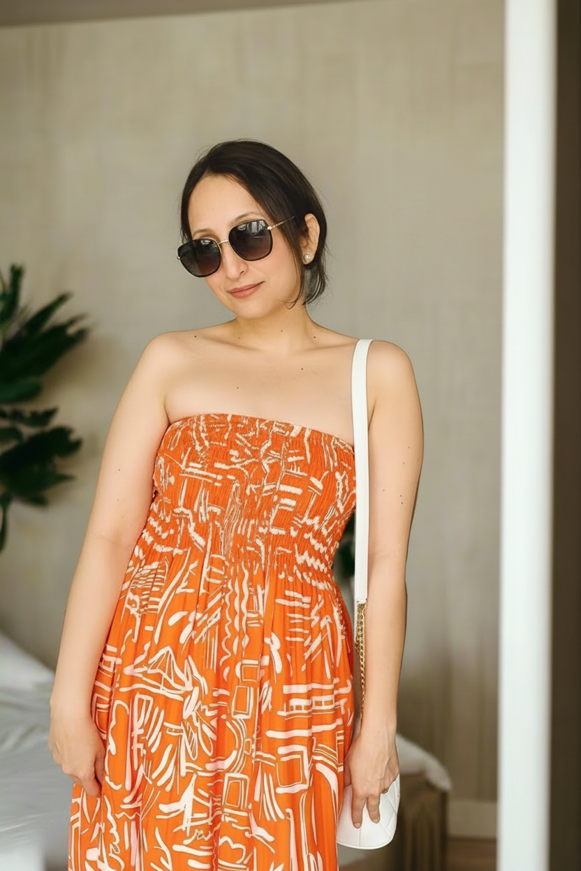 Sundown Strapless Midi Dress
is a playful, versatile dress in geometric orange that seamlessly transitions from dress to skirt, giving you two looks in one effortless piece.