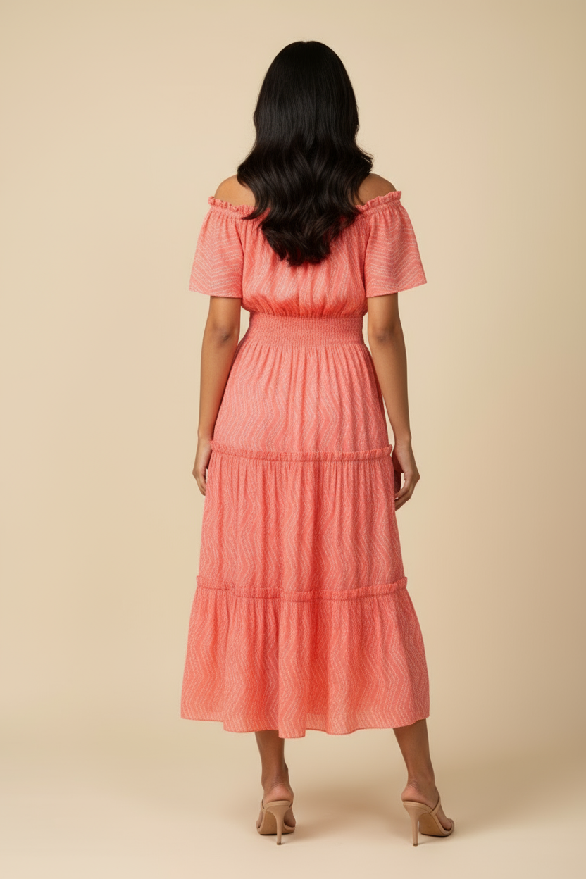 Back view of coral peach midi dress showing tiered layers and shirred waist