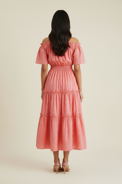 Woman wearing a pink off-shoulder dress against a beige background