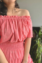A gorgeous Flamingo Pink Mulmul Cotton Tiered Midi Dress that features a flattering shirred waist and a tiered silhouette. Wear it on or off the shoulders, depending upon your mood-looks great either way