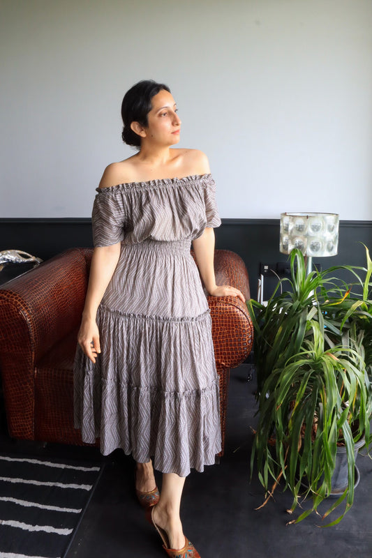 Grey color midi dress with shirred waist and tiered skirt. It can be worn off the shoulder as well. Its fully lined with pure cotton fabric. Wear it for a brunch or a walk around town. 