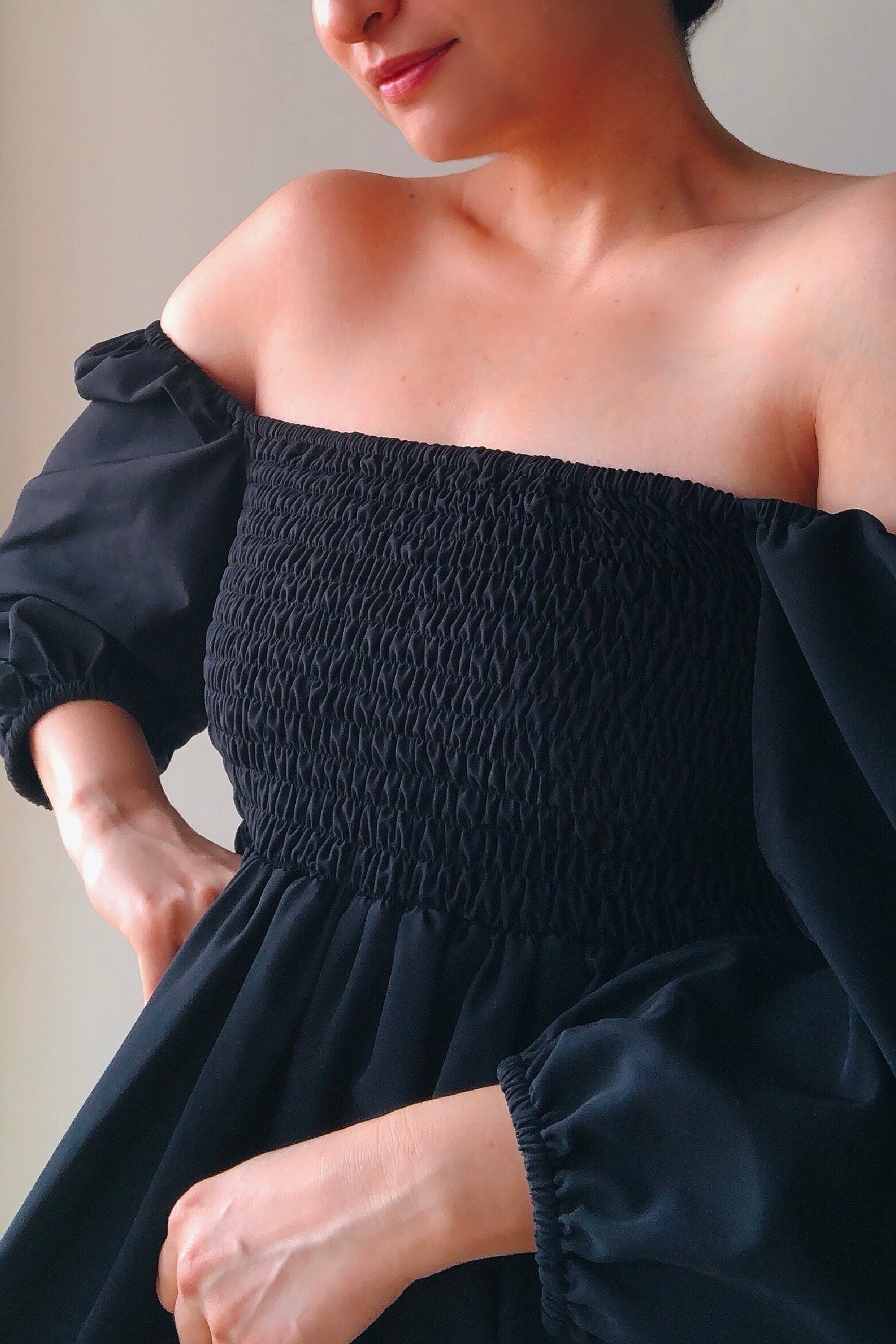 Aurora black dress is ankle length with smocking on the back and a wrap bodice that can be tied into a knot.  It can be worn in reverse as well with smocking in the front. Its made with love from a beautiful imported crepe.